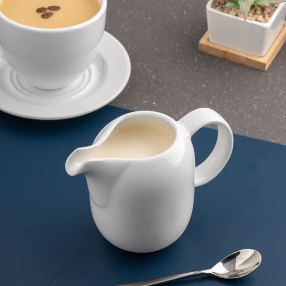 Ariane Vital Coupe 11.83 oz. Warm White Porcelain Creamer with Handle - 6/Case