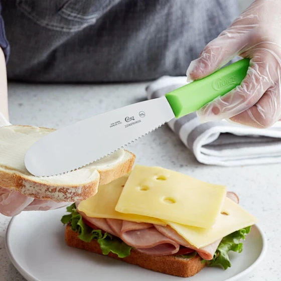 Choice 5 1/2" Scalloped Stainless Steel Sandwich Spreader with Neon Green Polypropylene Handle