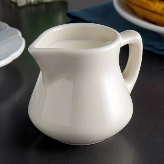 Tuxton BER-055 5.5 oz. Eggshell China Creamer with Handle - 12/Case