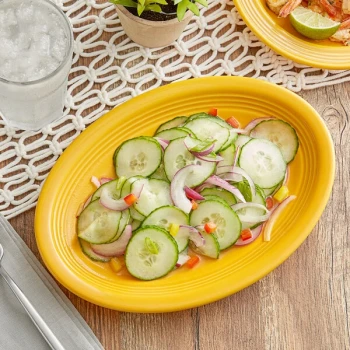 Acopa Capri 9 3/4" x 7" Mango Orange Oval Stoneware Coupe Platter - Sample