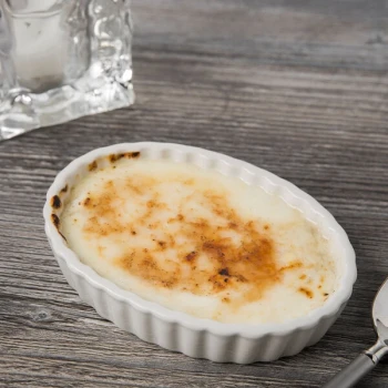 Tuxton BEK-0506 5 oz. Eggshell Oval Fluted China Souffle / Creme Brulee Dish - 24/Case