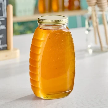 24 oz. (32 oz. Honey Weight) Classic Queenline Glass Honey Jar with Plastisol-Lined Gold Metal Lid - 96/Case