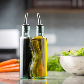 TableCraft 918RSN Gemelli 8.5 oz. 3 Piece Clear Glass Oil and Vinegar Cruet Set with Stainless Steel Rack