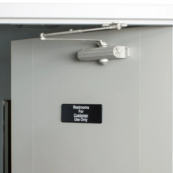 Vollrath 4525 Traex® Restrooms For Customer Use Only Sign - Black and White, 9" x 3"