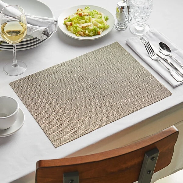 Front of the House Metroweave 16" x 12" Tan Rush Woven Vinyl Rectangle Placemat - 12/Pack