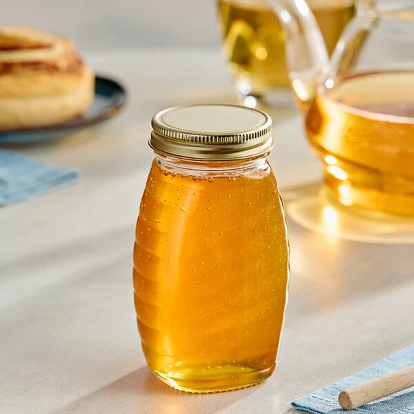 5.5 oz. (8 oz. Honey Weight) Classic Queenline Glass Honey Jar with Plastisol-Lined Gold Metal Lid - 96/Case