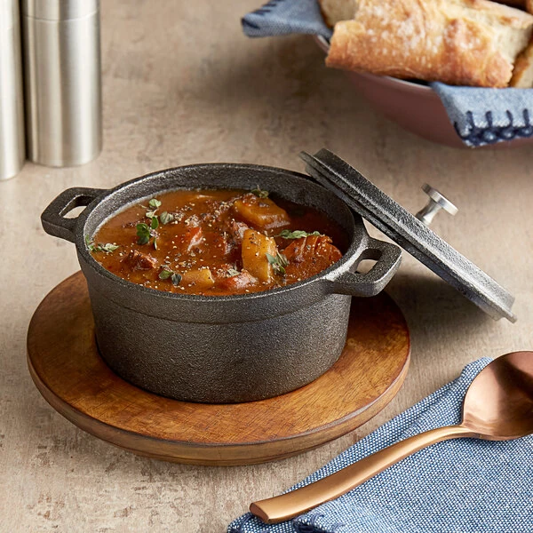 Valor 16 oz. Pre-Seasoned Mini Cast Iron Pot with Rustic Chestnut Finish Rubberwood Underliner