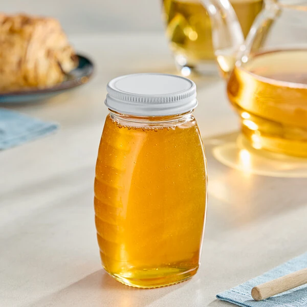 5.5 oz. (8 oz. Honey Weight) Classic Queenline Glass Honey Jar with Plastisol-Lined White Metal Lid - 96/Case