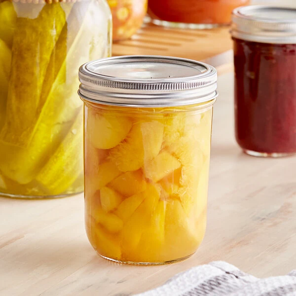 Choice 16 oz. Pint Wide Mouth Canning / Mason Jar with Silver Metal Lid and Band - 12/Case