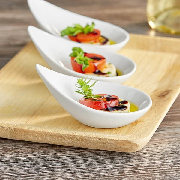 Acopa 2 oz. Bright White Porcelain Slant Appetizer / Tasting Spoon - 12/Pack