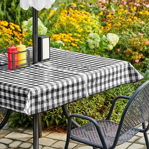 Choice 52" x 70" Black Textured Gingham Vinyl Table Cover with Umbrella Opening and Flannel Back
