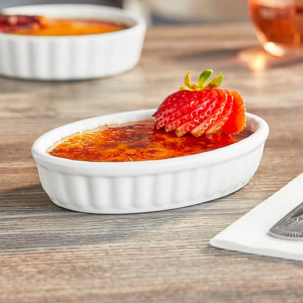 Acopa 6 oz. Oval Bright White Fluted Porcelain Souffle / Creme Brulee Dish - 36/Case