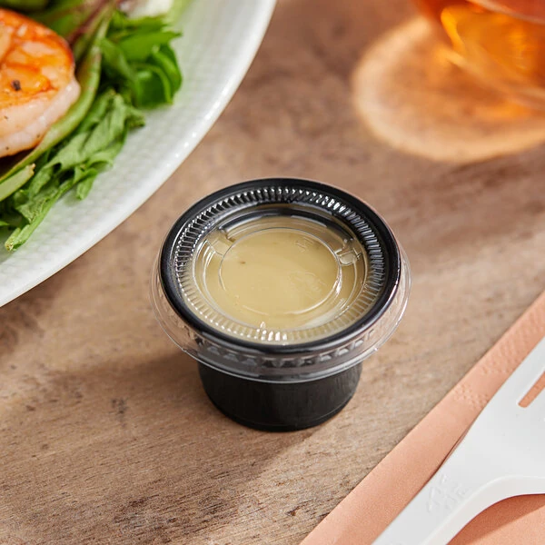 Choice 1 oz. Black Plastic Souffle Cup / Portion Cup with PET Plastic Lid - 100/Case