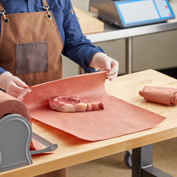 Choice 24'' x 700' 40 lb. Pink / Peach Butcher Paper Roll