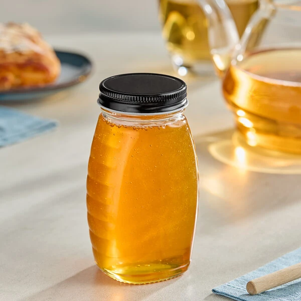 5.5 oz. (8 oz. Honey Weight) Classic Queenline Glass Honey Jar with Plastisol-Lined Black Metal Lid - 96/Case
